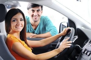 young woman sitting in car at the dealership