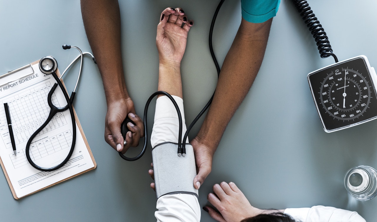 healthcare worker taking a patient's blood pressure