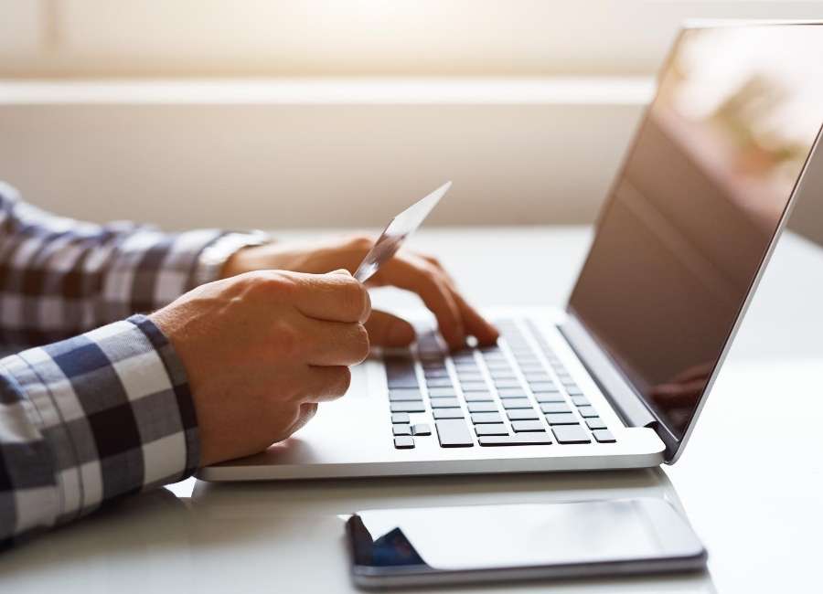 Man paying bills online with a credit card