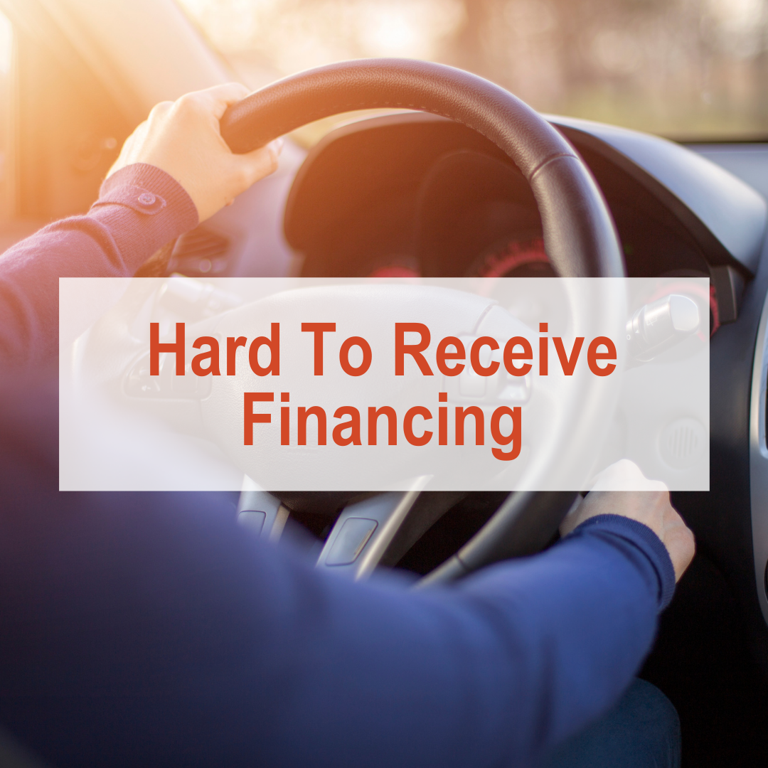 person with hands on car steering wheel | Hard To Receive Financing