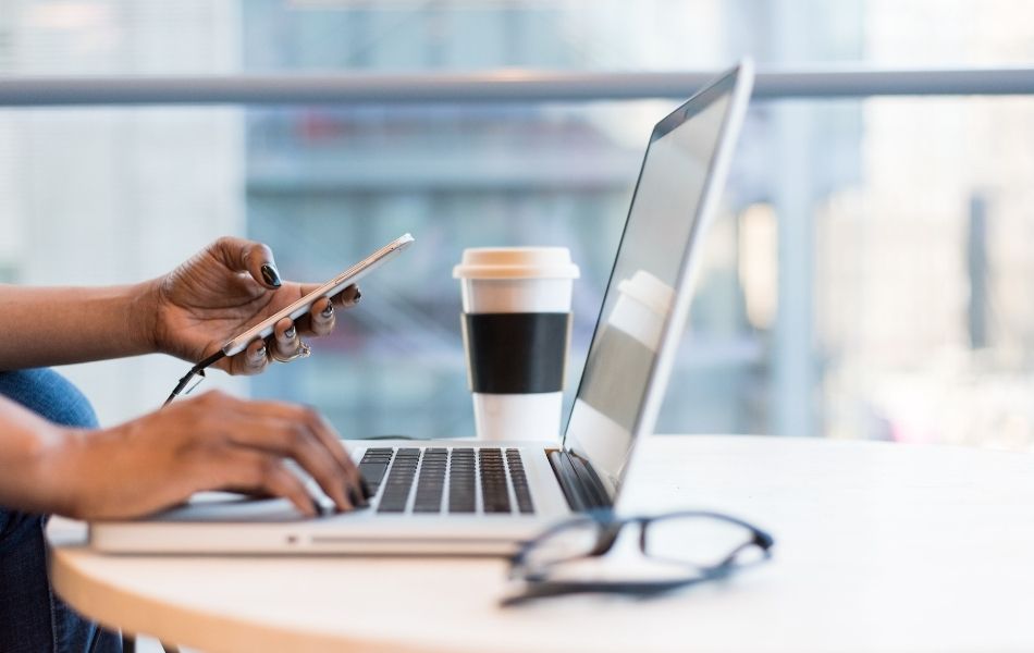 Woman using digital banking on desktop and phone