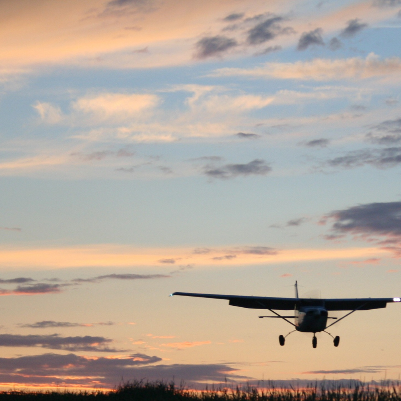 A sunrise with small plane in the air