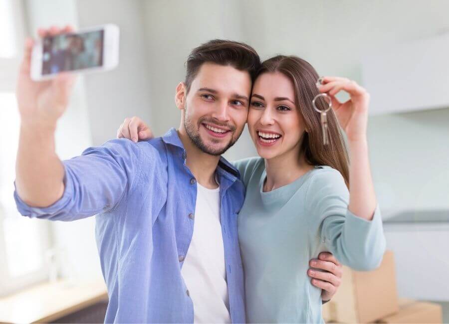 Couple holding up keys to their new home