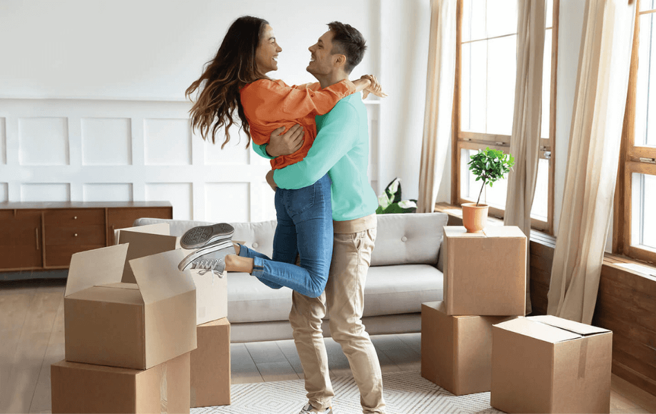 Woman jumping into man's arms - First Time Home Buyer Savings Program