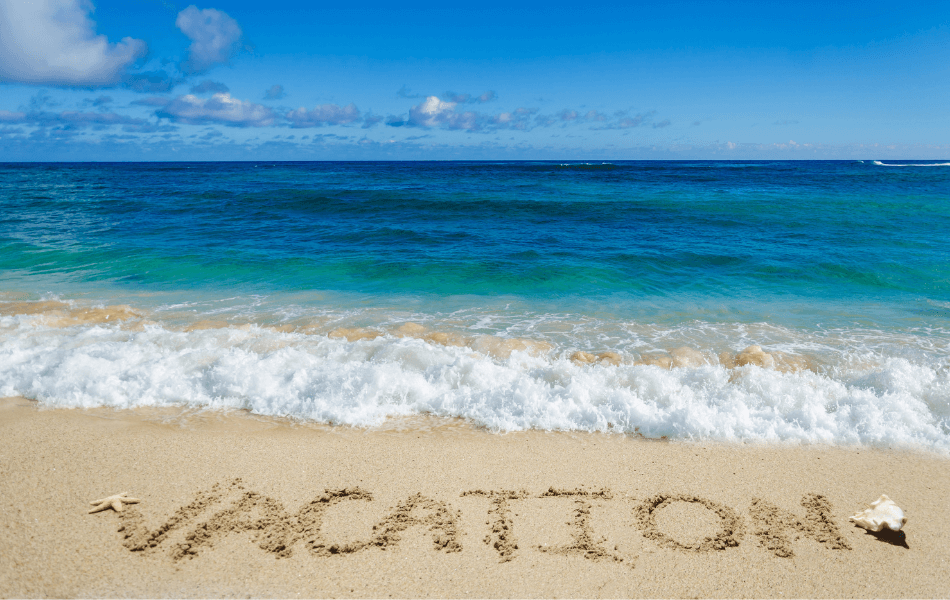Beach with "vacation" written in the sand