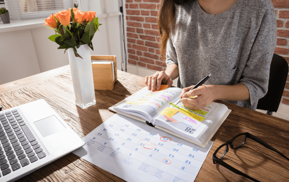 Person writing in a planner