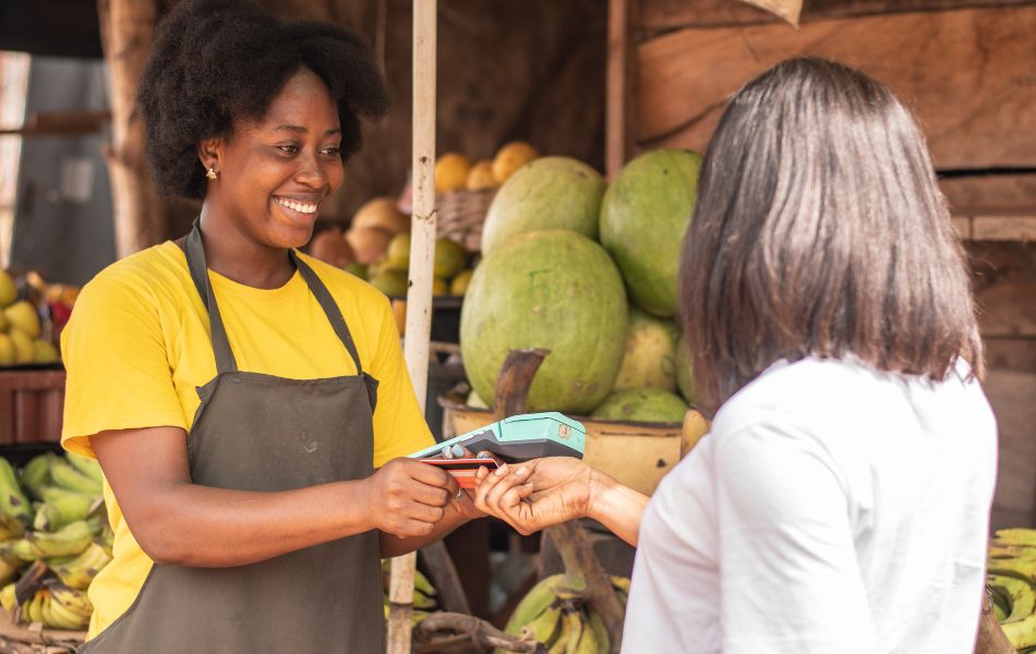 Woman paying at market with credit card