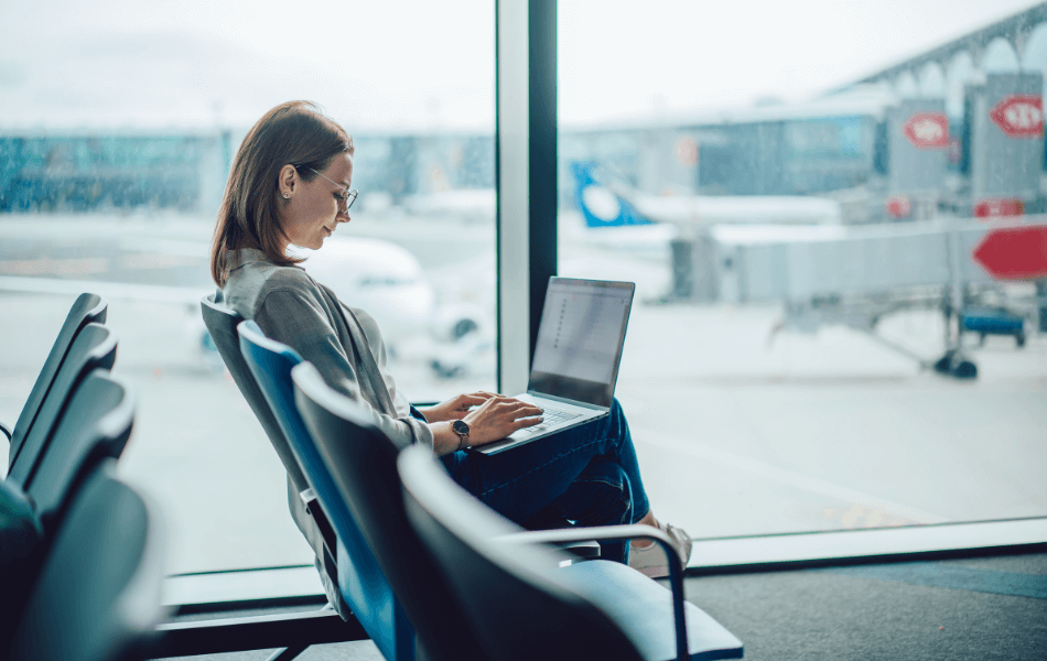 Person on their laptop at an airport