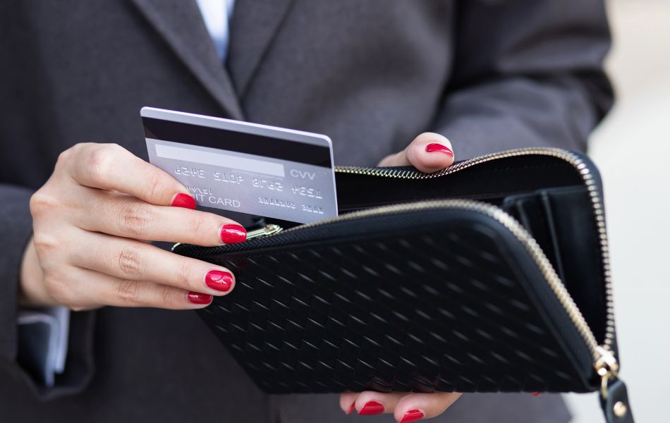 Woman Putting Credit Card Back in Wallet