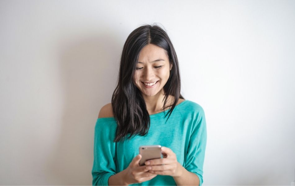 Woman smiling looking at phone