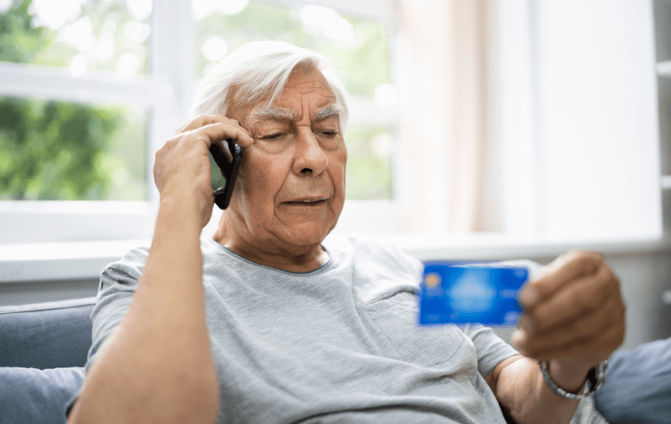 elderly person giving their credit card information over the phone