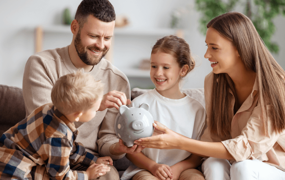 Family putting money in a piggy bank