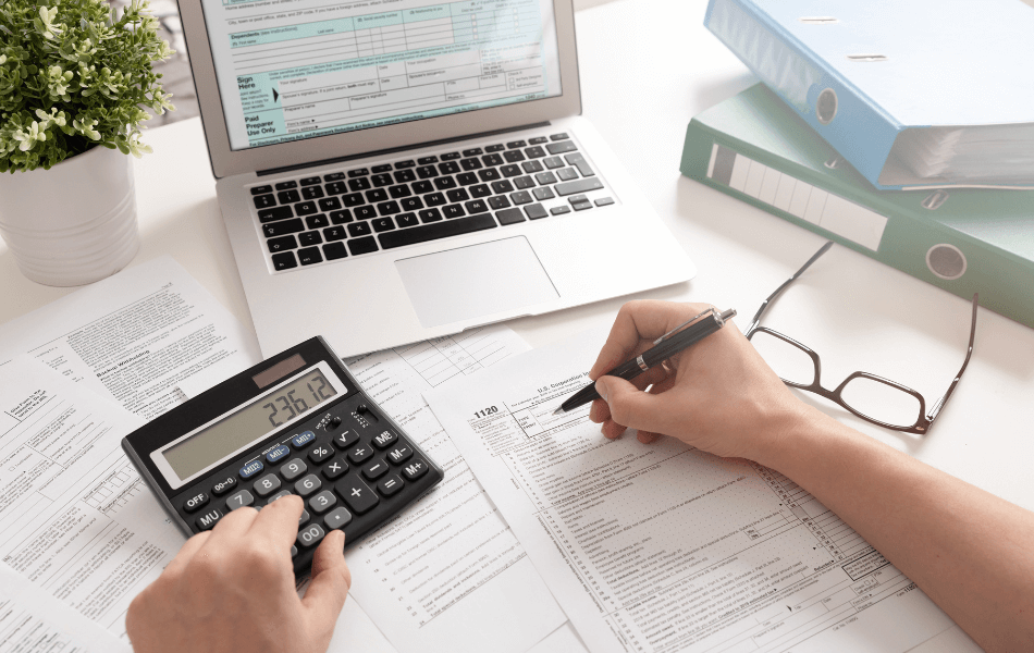Tax return, laptop, and calculator