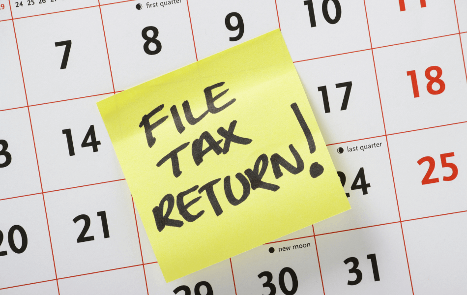 Post-it note on calendar saying "File Tax Return!"