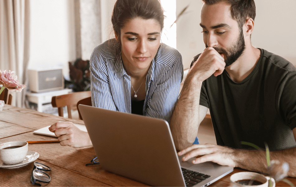 Couple looking at a laptop together