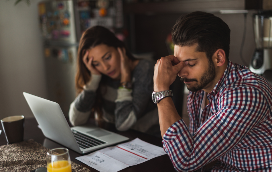 Stressed couple looking at bills