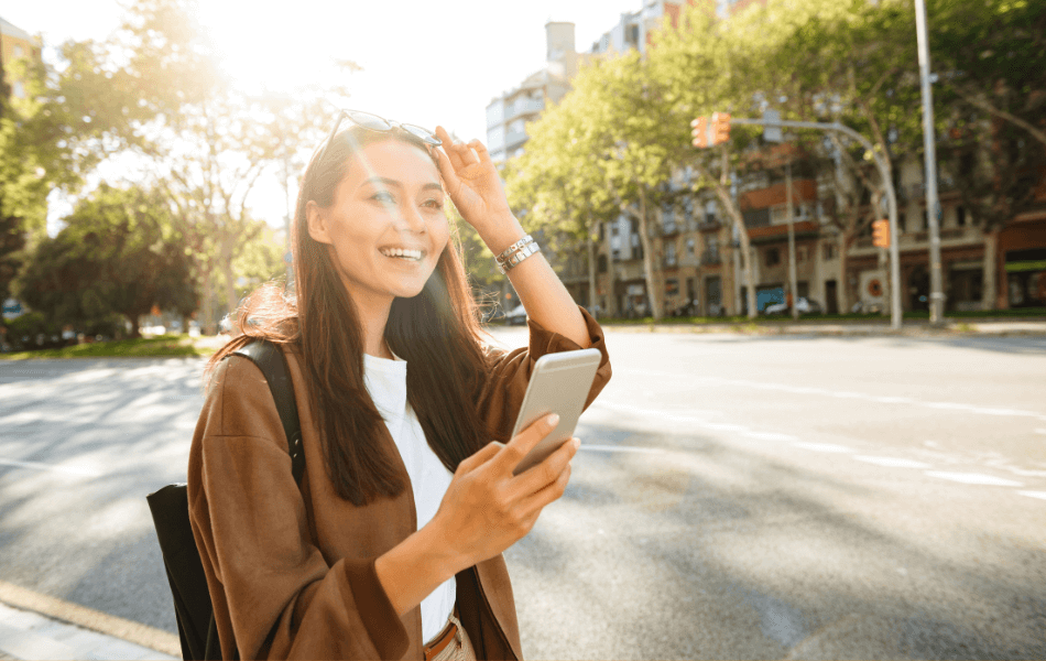 Woman smiling and holding her phone