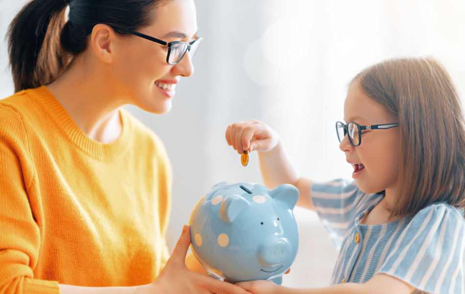 Kid putting money in piggy bank with woman