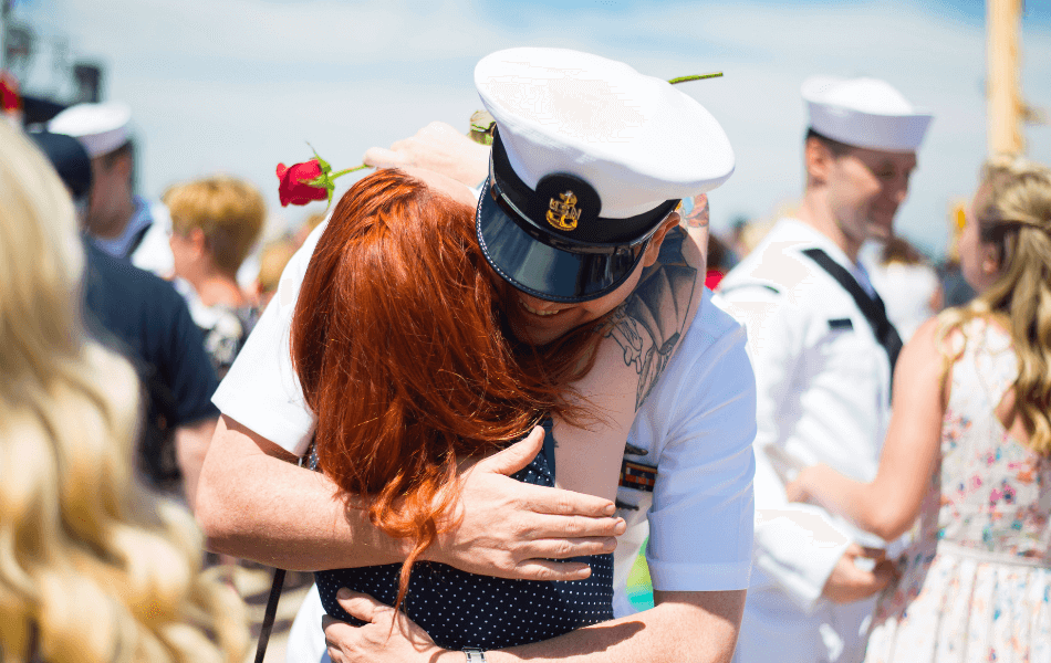 Active Duty Military hugging spouse