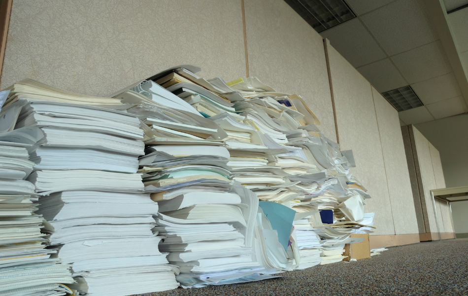 stacks of papers and files on the ground
