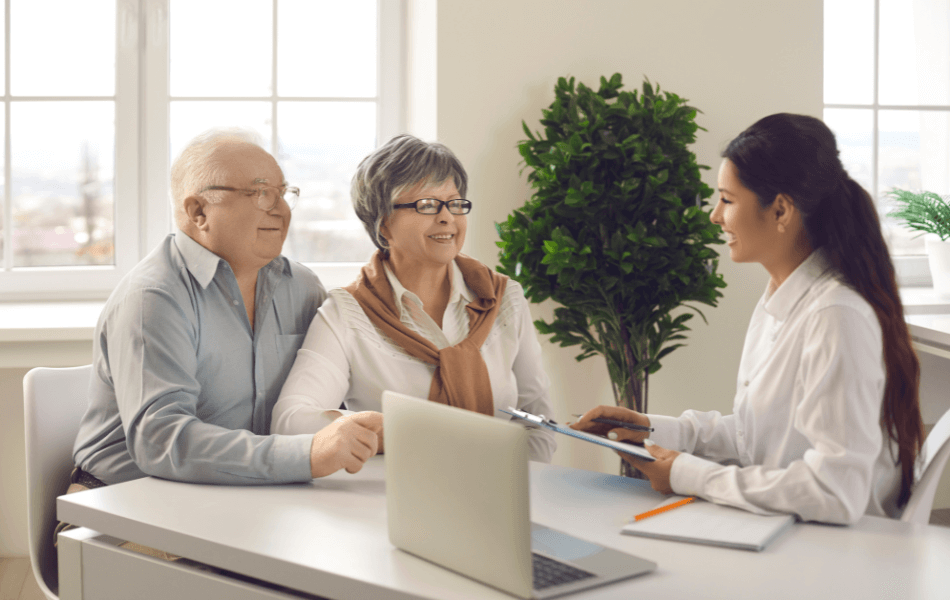 Older couple going over paperwork with a lady