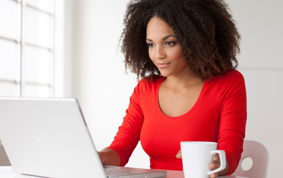 Person with a laptop and coffee mug