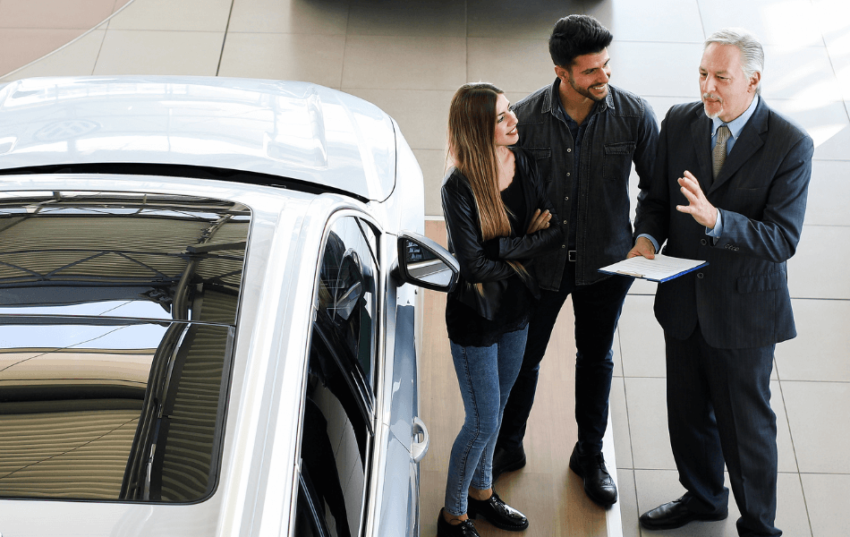 Couple talking to a car salesman