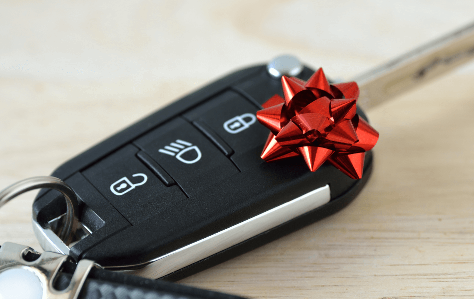 Car keys with a small, red bow on top