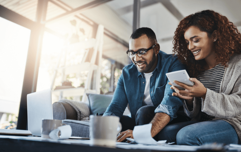 Couple using a laptop and calculator