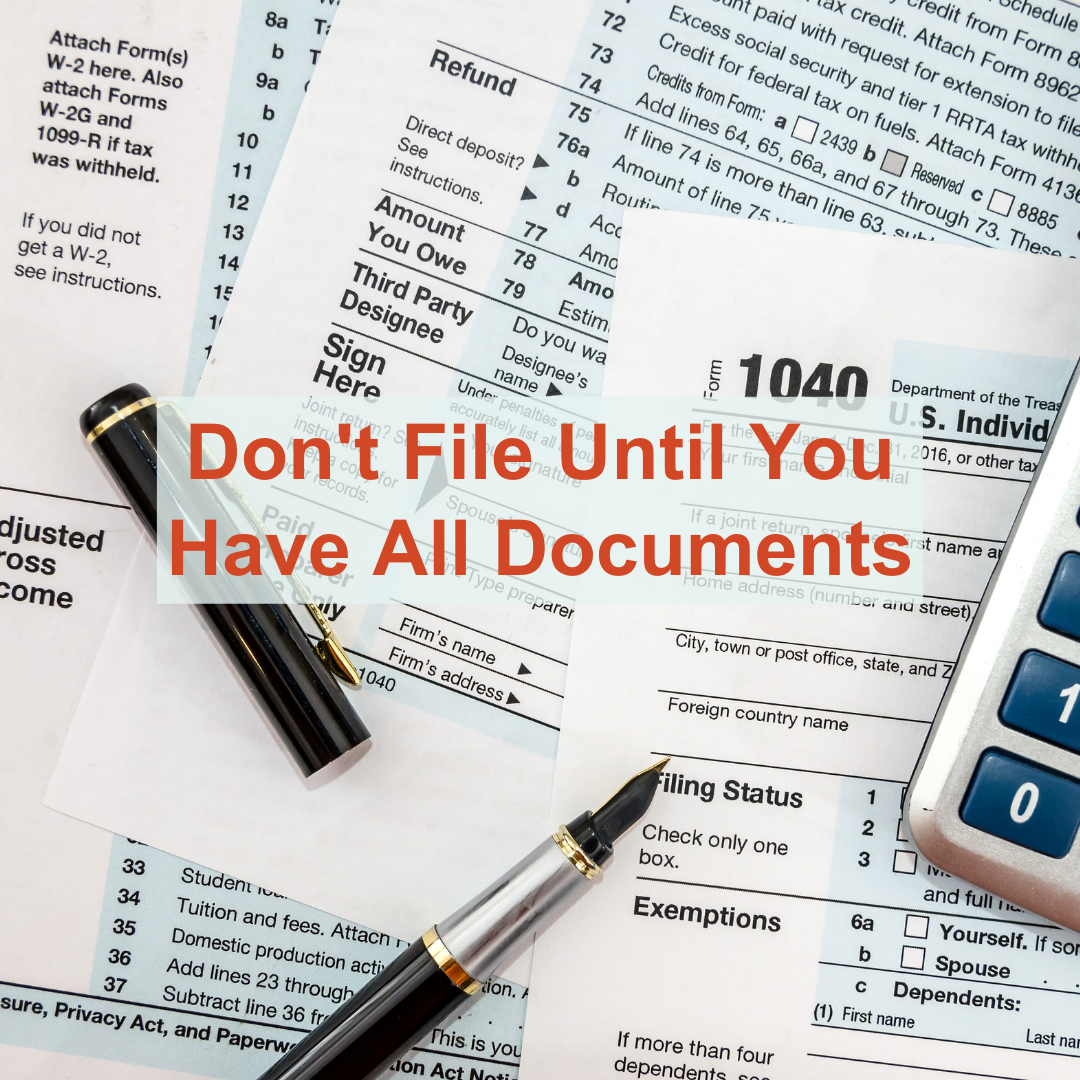Don't File Until You Have All Documents text in front of tax forms on a table