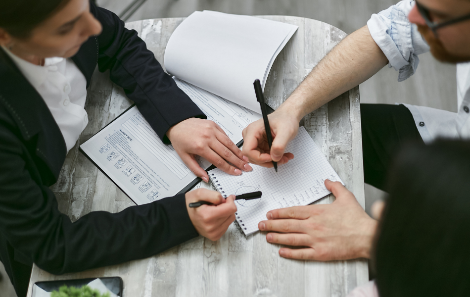 Consolidate Debt with A Personal Loan - a man and woman looking over documents on a table together