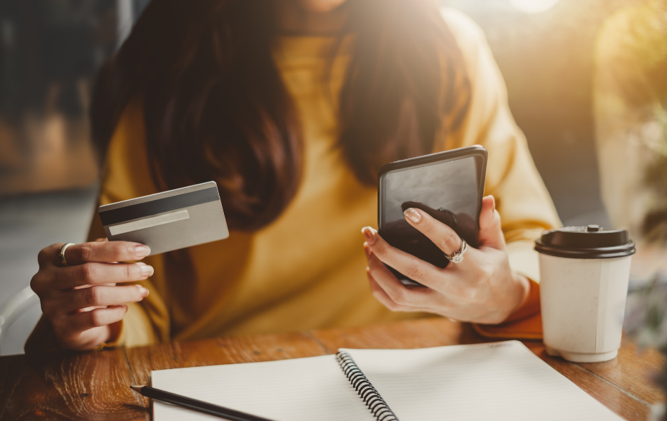 Stop Spending on Credit - Woman online shopping on phone using a credit card to pay