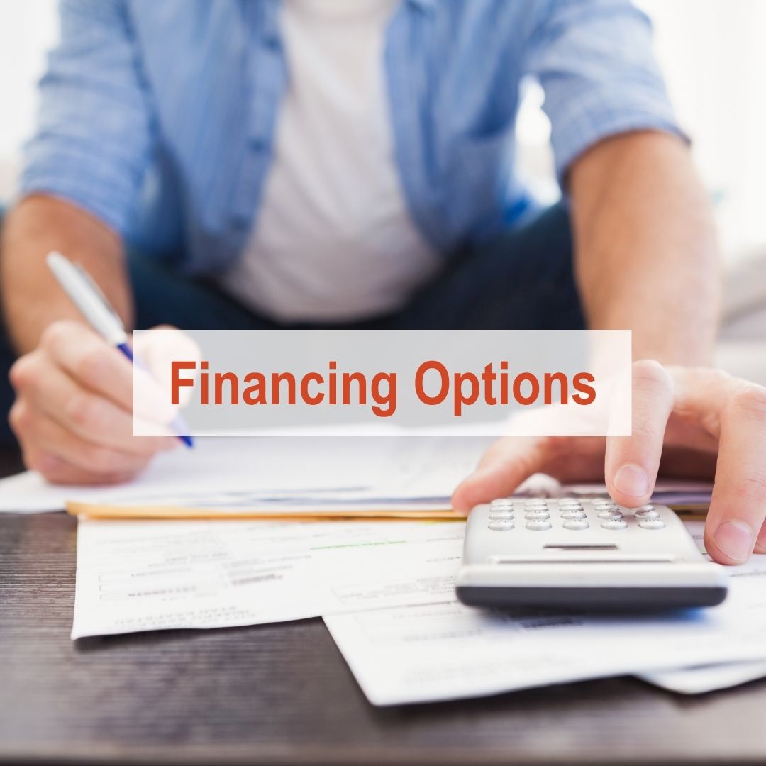 person sitting at table going over papers with calculator | Financing Options
