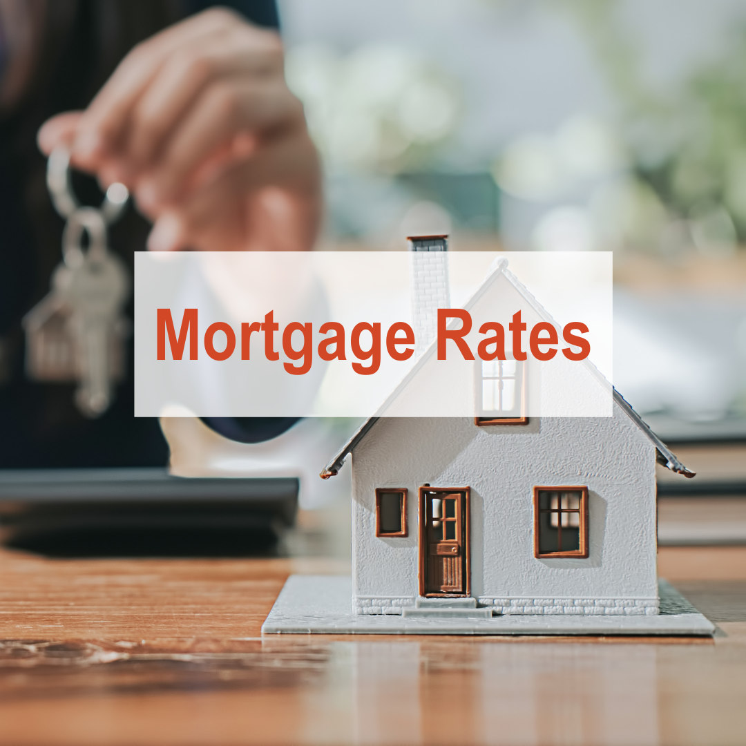 person holding key with miniature house in front | mortgage rates
