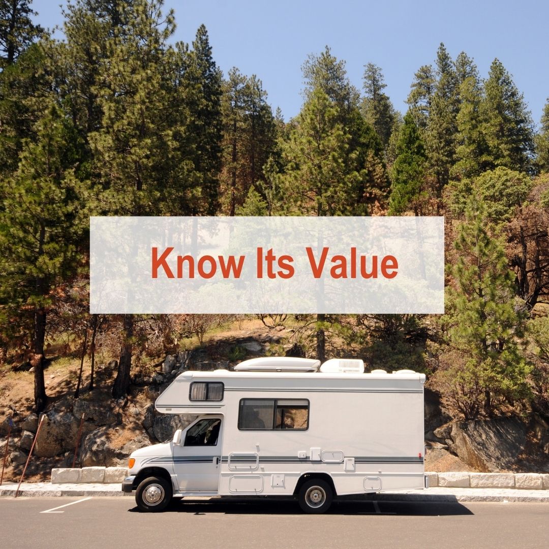 RV parked on road with pine trees in the back | Know its Value