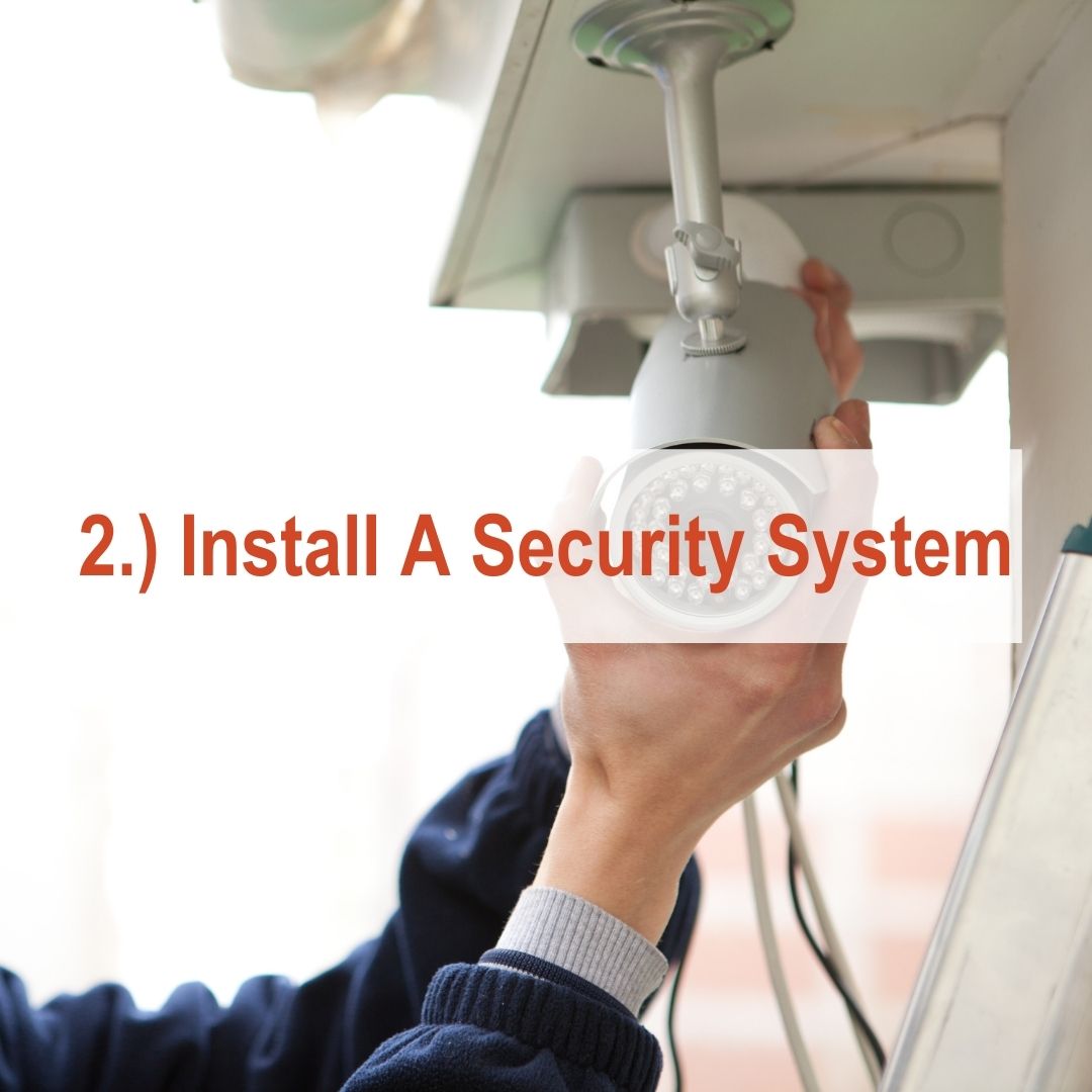 hand installing security camera on roof | Install A Security System
