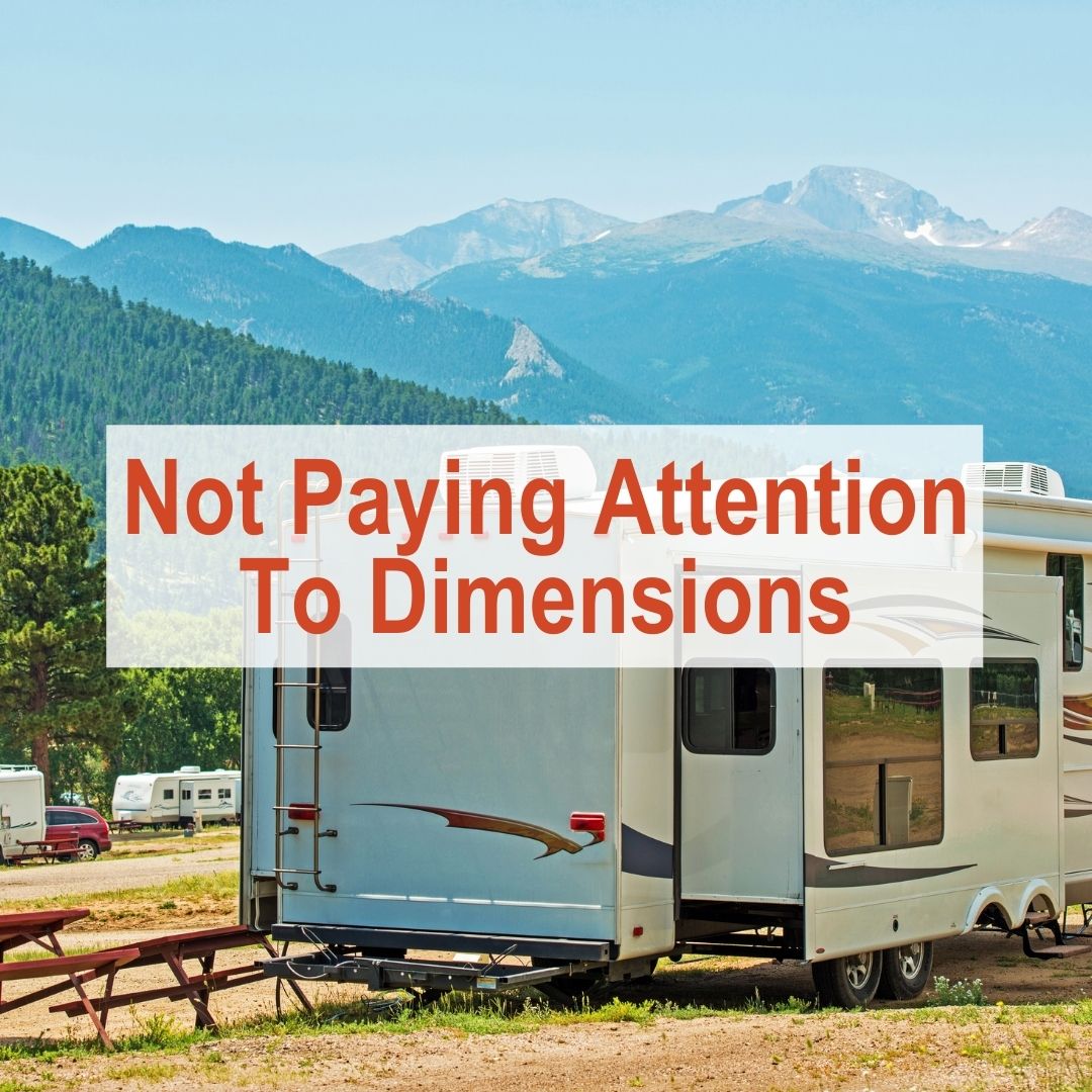 RV parked along fence line with mountains in the background | Not paying attention to dimensions