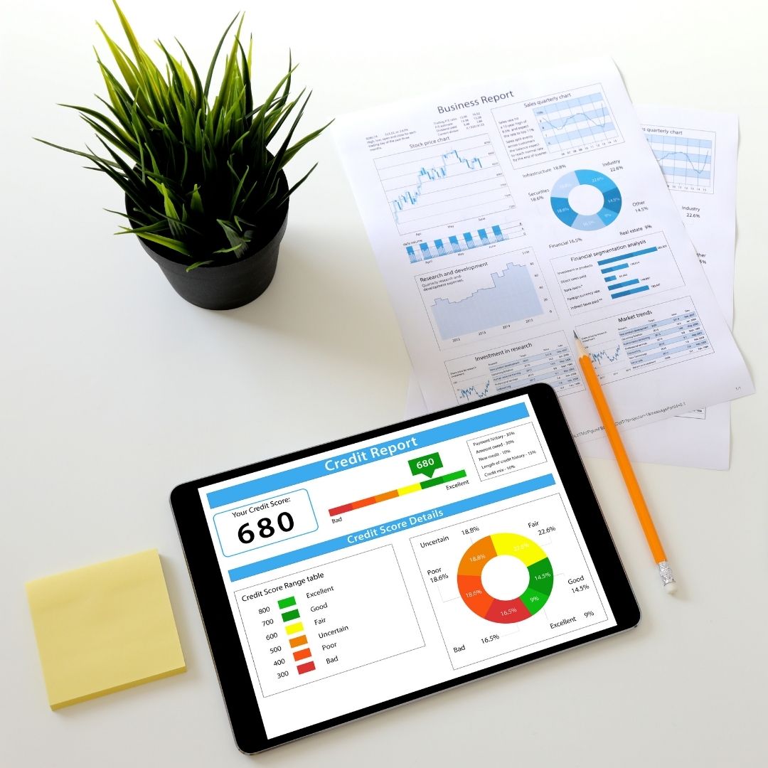 desk with ipad and papers featuring credit score information