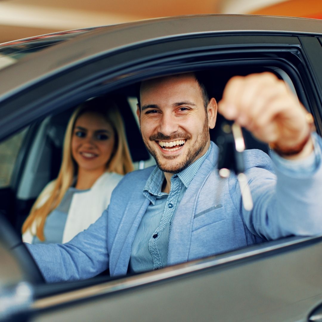 guy smiling in car with woman in passenger seat