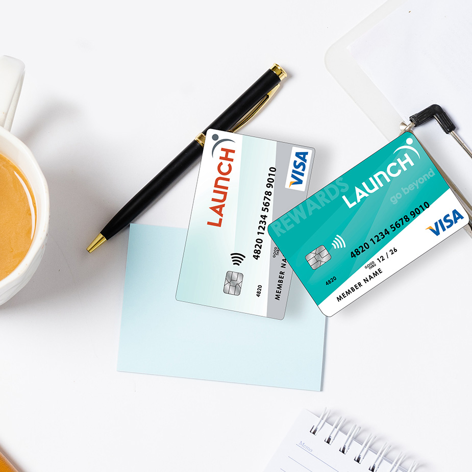 Two Launch Credit Cards on desk with a cup of coffee